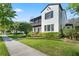 Attractive two-story home featuring a balcony, neutral stucco, and lush landscaping with a sidewalk view at 4457 Anson Ln, Orlando, FL 32814