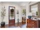 Welcoming foyer with dark wood floors, detailed millwork, and natural light from shuttered windows at 4457 Anson Ln, Orlando, FL 32814