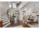 Elegant foyer featuring a grand staircase, hardwood floors, and a view of the dining room at 4457 Anson Ln, Orlando, FL 32814