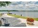 Scenic view of the lake with a pier and gazebo, surrounded by lush greenery and vibrant flower pots at 4457 Anson Ln, Orlando, FL 32814