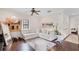 Relaxing living room featuring a plush white sectional, exercise equipment, and wood floors for a comfortable atmosphere at 4457 Anson Ln, Orlando, FL 32814