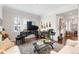 Cozy living room featuring a grand piano, hardwood floors, comfortable seating, and natural light at 4457 Anson Ln, Orlando, FL 32814