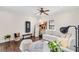 Comfortable living room featuring a plush white sectional, exercise equipment, and wood floors for a cozy atmosphere at 4457 Anson Ln, Orlando, FL 32814