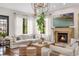 Cozy living room with a stone fireplace, comfortable seating, hardwood floors, and natural light at 4457 Anson Ln, Orlando, FL 32814