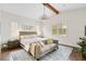 Bright main bedroom showcasing a decorative rug, elegant chandelier, and natural light from shuttered windows at 4457 Anson Ln, Orlando, FL 32814