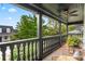 Outdoor porch boasts black railing and ceiling fan with a lovely seating area at 4457 Anson Ln, Orlando, FL 32814