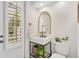 Charming powder room featuring stylish sink, mirror, and tiled flooring with a window providing natural light at 4457 Anson Ln, Orlando, FL 32814