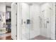 Bright shower featuring glass enclosure, seat, and a view to an expansive closet at 4457 Anson Ln, Orlando, FL 32814