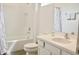 Bright bathroom features a white vanity, toilet, and shower with white subway tile and a patterned shower curtain at 4489 Monado Dr, Kissimmee, FL 34746