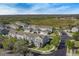 Aerial view of townhomes with lake and field in distance at 502 Rainbow Springs Loop, Groveland, FL 34736