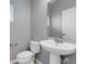 Modern bathroom featuring a pedestal sink and a stylish mirror, designed for functionality and aesthetics at 502 Rainbow Springs Loop, Groveland, FL 34736