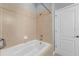 Relaxing bathroom featuring a soaking tub and tiled walls, creating a spa-like atmosphere at 502 Rainbow Springs Loop, Groveland, FL 34736