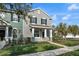 Inviting exterior view of a two-story townhome with a quaint porch and landscaped front yard at 502 Rainbow Springs Loop, Groveland, FL 34736