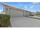 Attached garages with driveway in front of homes at 502 Rainbow Springs Loop, Groveland, FL 34736