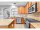 Kitchen with granite countertops, stainless steel appliances, and modern cabinets at 502 Rainbow Springs Loop, Groveland, FL 34736