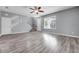 Bright and airy living room with modern floors, fresh paint, and a staircase at 502 Rainbow Springs Loop, Groveland, FL 34736