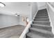 Carpeted staircase leading to the upper level, offering a seamless transition between living spaces at 502 Rainbow Springs Loop, Groveland, FL 34736