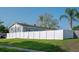 Wide shot of backyard and white fence on a well-manicured lawn at 504 Teakwood Dr, Altamonte Springs, FL 32714