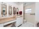 Bright bathroom features a vanity with three decorative mirrors, great lighting, and plenty of storage at 504 Teakwood Dr, Altamonte Springs, FL 32714