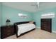 Cozy bedroom with light blue walls, a daybed, and wood-look flooring; ceiling fan included at 504 Teakwood Dr, Altamonte Springs, FL 32714