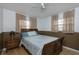 Bedroom featuring a light-colored wood floor, and a dark wood bedframe, side table, and two windows at 504 Teakwood Dr, Altamonte Springs, FL 32714