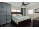 Comfortable bedroom with a dark wood bed frame, ceiling fan, and modern frosted wardrobes for ample storage at 504 Teakwood Dr, Altamonte Springs, FL 32714