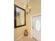 Front entry door beside a decorative mirror and chandelier at 504 Teakwood Dr, Altamonte Springs, FL 32714