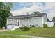 Charming home with an attached garage, well-manicured front yard and a bright red door at 504 Teakwood Dr, Altamonte Springs, FL 32714