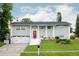 Charming two-story home with a red front door, white columns and a well-manicured lawn at 504 Teakwood Dr, Altamonte Springs, FL 32714