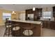 Kitchen island featuring granite countertops and bar stool seating with views of the dining area at 504 Teakwood Dr, Altamonte Springs, FL 32714