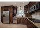 Kitchen featuring stainless steel appliances, dark wood cabinetry, and granite countertops at 504 Teakwood Dr, Altamonte Springs, FL 32714