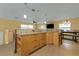 Open kitchen featuring granite countertops and a breakfast bar with views of the living room at 504 Teakwood Dr, Altamonte Springs, FL 32714