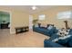 Comfortable living room with light-filled window, blue sofa, and soft lamp lighting at 504 Teakwood Dr, Altamonte Springs, FL 32714