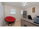 Bright home office with hardwood floors, desk space, and a comfortable red papasan chair at 504 Teakwood Dr, Altamonte Springs, FL 32714