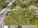 Aerial view of a home featuring a large shade tree, fenced yard and mature landscaping at 505 E Plymouth Ave, Deland, FL 32724