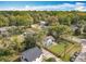 A sunny day view of the neighborhood shows the home and its lush landscaping at 505 E Plymouth Ave, Deland, FL 32724