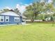 Large backyard with a beautiful lawn and mature landscaping at 505 E Plymouth Ave, Deland, FL 32724