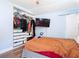 Bedroom showcasing a closet, television, barn door, and natural light at 505 E Plymouth Ave, Deland, FL 32724