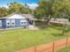 This single-story home features a spacious front yard with a wood fence at 505 E Plymouth Ave, Deland, FL 32724