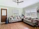 Bright living room with hardwood floors, neutral-toned furniture, and classic trim at 505 E Plymouth Ave, Deland, FL 32724