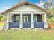 A covered front porch featuring white pillars and an overhead ceiling fan at 505 E Plymouth Ave, Deland, FL 32724