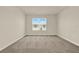 Light-filled bedroom with plush carpeting, bright window and neutral color scheme at 5063 Marshelder St, Apopka, FL 32712