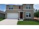 Charming two-story home with a two-car garage, and a well-maintained lawn at 5063 Marshelder St, Apopka, FL 32712