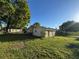 The backyard has a grassy lawn with trees for shade at 508 W Crescent Dr, Lakeland, FL 33805