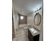 Well-lit bathroom featuring stylish vanity, and shower with decorative tile accents at 508 W Crescent Dr, Lakeland, FL 33805