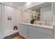 Elegant bathroom with double vanity, white cabinetry, walk-in shower, and modern finishes at 5087 Marshelder St, Apopka, FL 32712