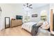 Relaxing bedroom with a bed, wooden dresser, and natural light from arched windows at 5101 The Oaks Cir, Orlando, FL 32809