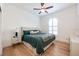 Inviting bedroom featuring a upholstered headboard and window that provides natural light at 5101 The Oaks Cir, Orlando, FL 32809