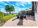 Relaxing outdoor patio featuring brick pavers, cozy seating, and a serene lake view at 5101 The Oaks Cir, Orlando, FL 32809