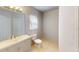 Bright bathroom featuring a modern vanity, a large mirror, and tile flooring at 5132 Luna Negra Dr, Orlando, FL 32811